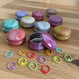 Marbled tins with spiral stitch markers