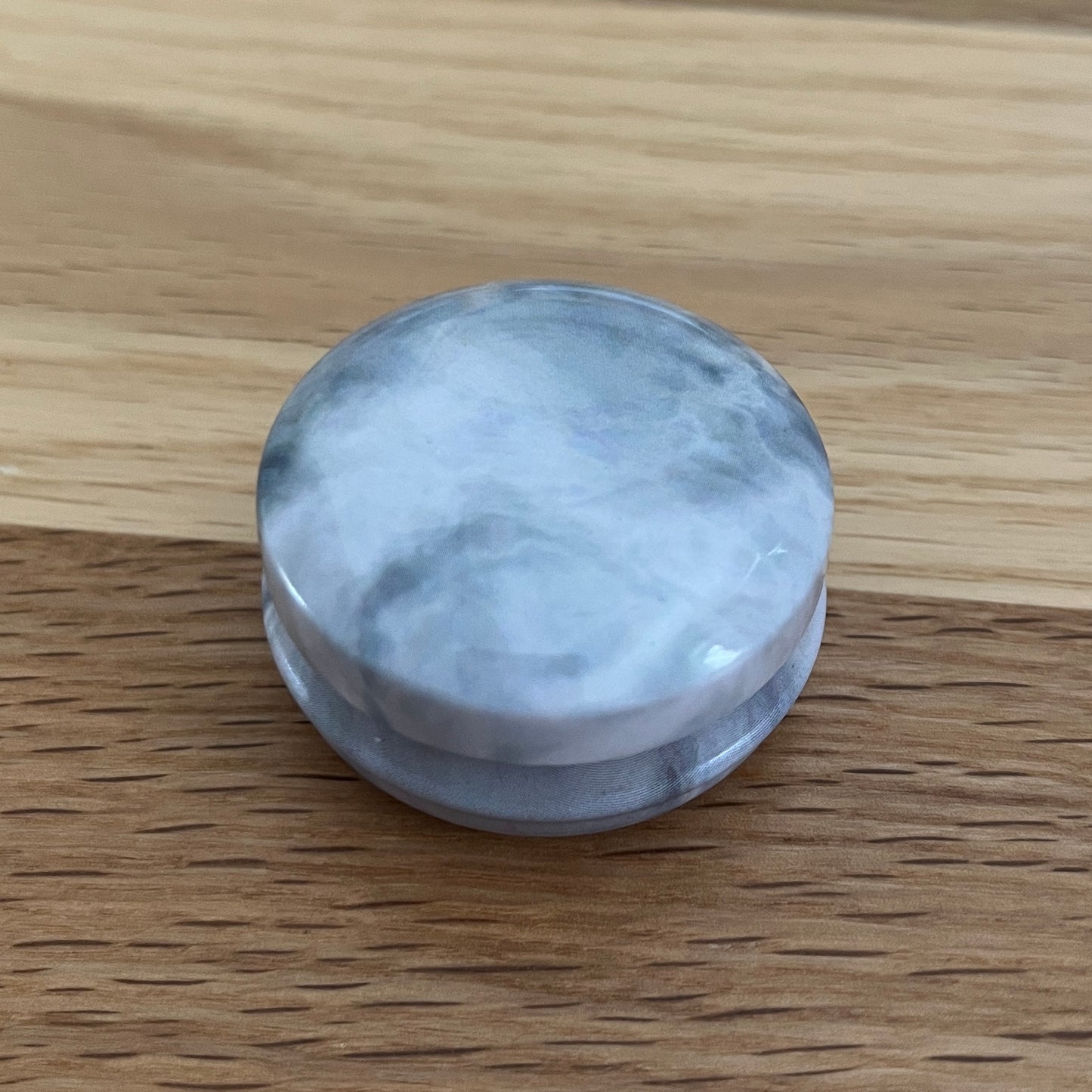Marbled tins with spiral stitch markers