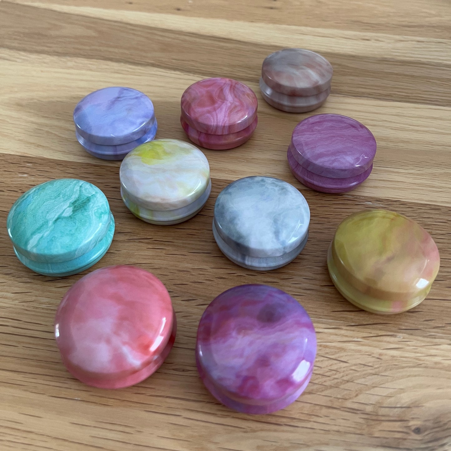 Marbled tins with spiral stitch markers